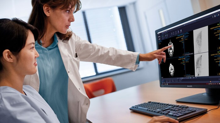 Radiologists pointing at a screen