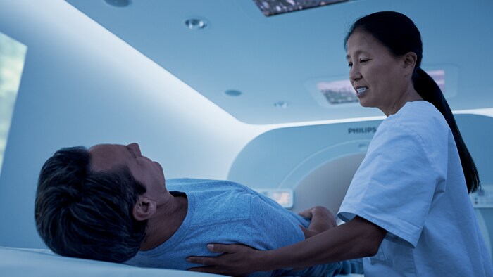 Technologist preparing patient for an imaging exam in a calming immersive environment
